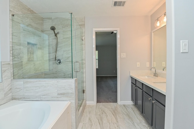 bathroom with vanity and independent shower and bath