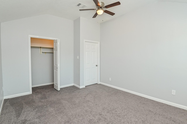 unfurnished bedroom with a closet, dark carpet, ceiling fan, and lofted ceiling