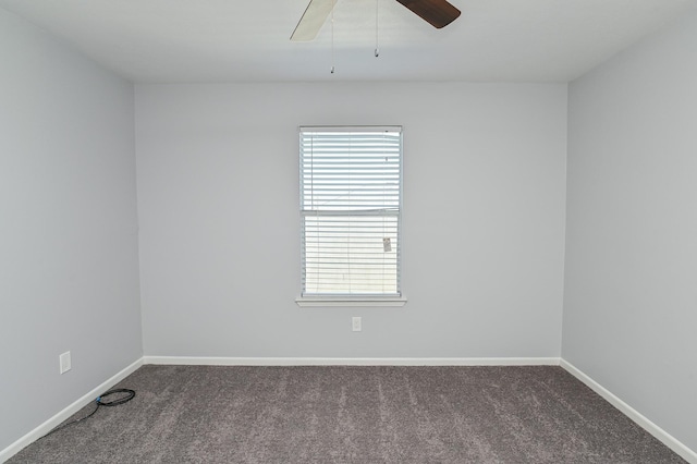 unfurnished room featuring dark carpet