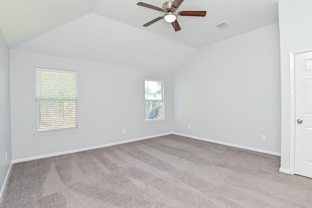 unfurnished room with ceiling fan, light carpet, and vaulted ceiling