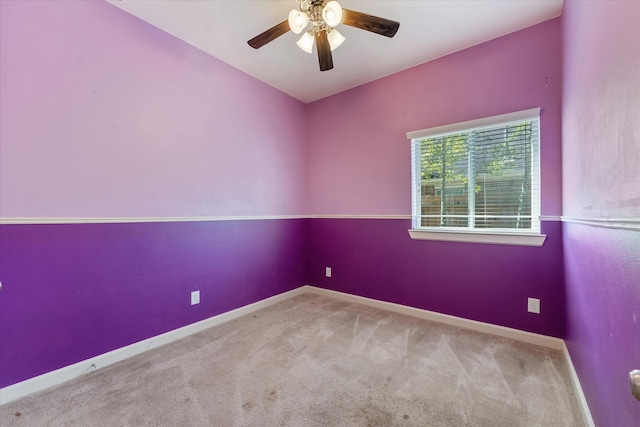 carpeted spare room with ceiling fan