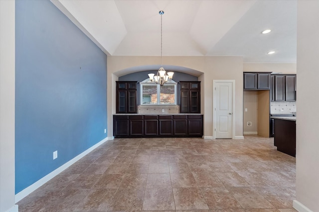 unfurnished dining area featuring vaulted ceiling and a notable chandelier