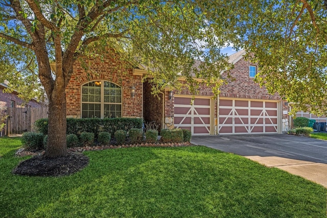 view of front of house with a front yard and a garage