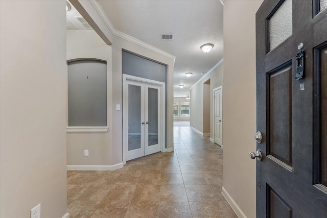 entrance foyer with ornamental molding and french doors