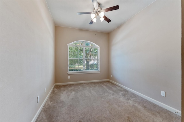 carpeted spare room featuring ceiling fan