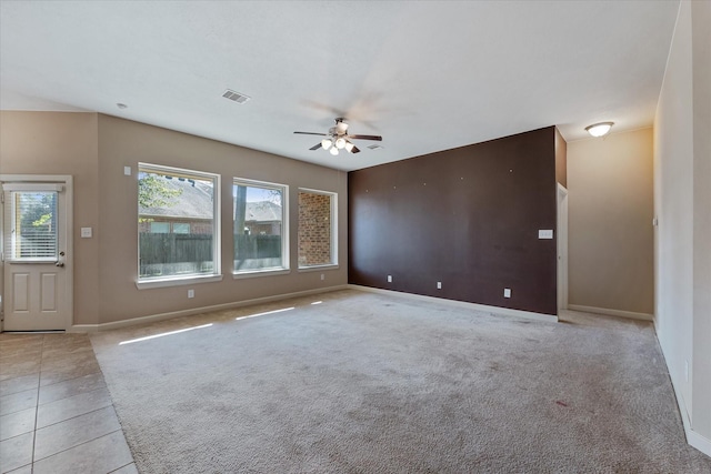 unfurnished living room with ceiling fan and light carpet