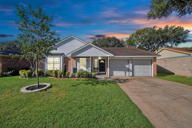 ranch-style home featuring a garage and a yard