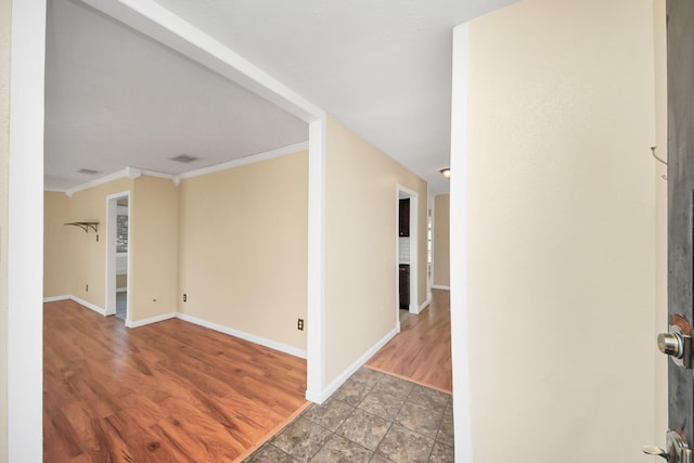 interior space with wood-type flooring and ornamental molding