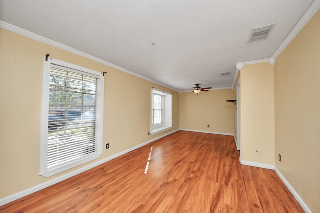 spare room with light hardwood / wood-style flooring, ceiling fan, and crown molding