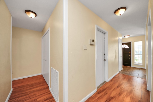 corridor with wood-type flooring