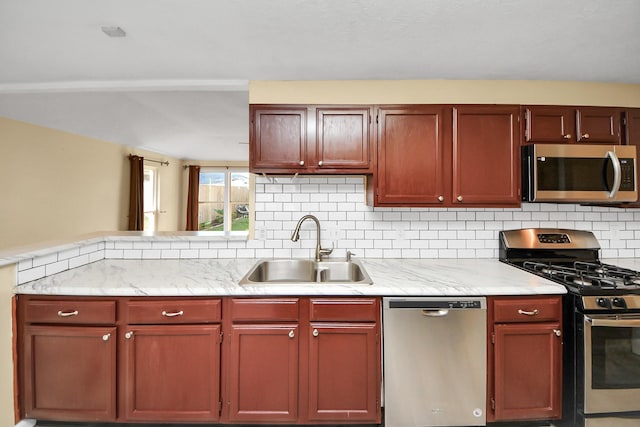 kitchen featuring appliances with stainless steel finishes, tasteful backsplash, and sink