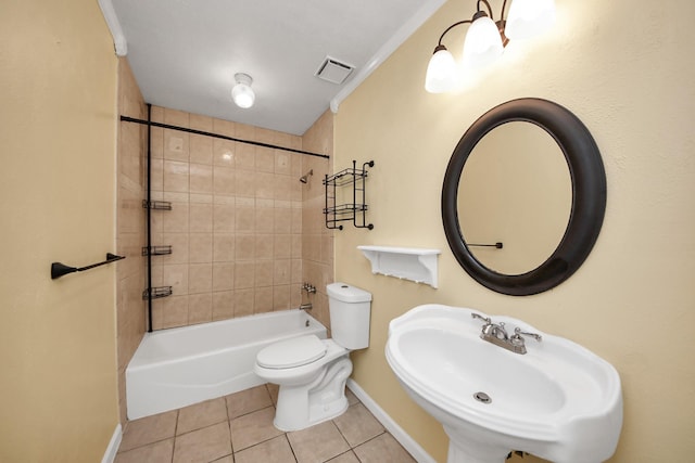 full bathroom with tiled shower / bath combo, crown molding, sink, tile patterned flooring, and toilet