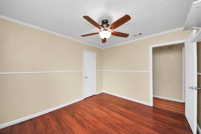 unfurnished bedroom featuring ceiling fan, dark hardwood / wood-style floors, ornamental molding, and a closet