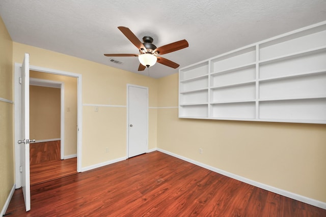 unfurnished bedroom with wood-type flooring, a textured ceiling, and ceiling fan