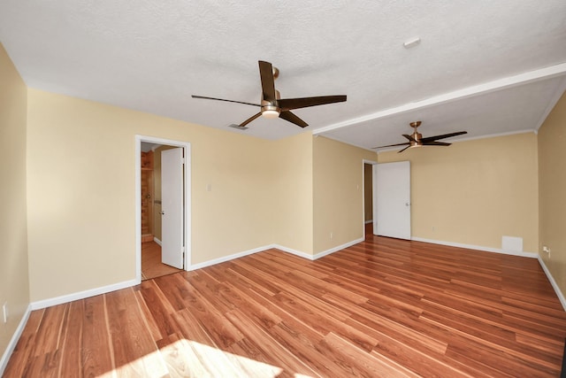 spare room with ceiling fan, light hardwood / wood-style flooring, and a textured ceiling