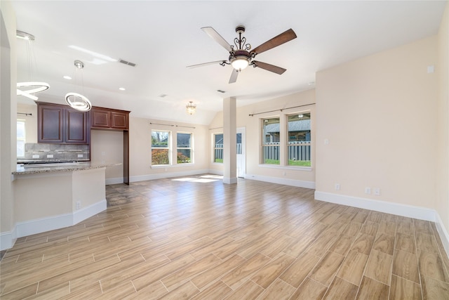 unfurnished living room featuring ceiling fan and lofted ceiling