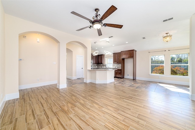 unfurnished living room featuring ceiling fan