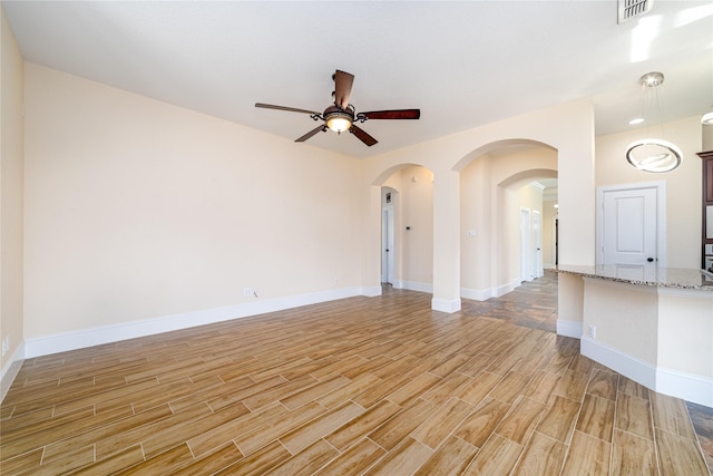 unfurnished room with ceiling fan