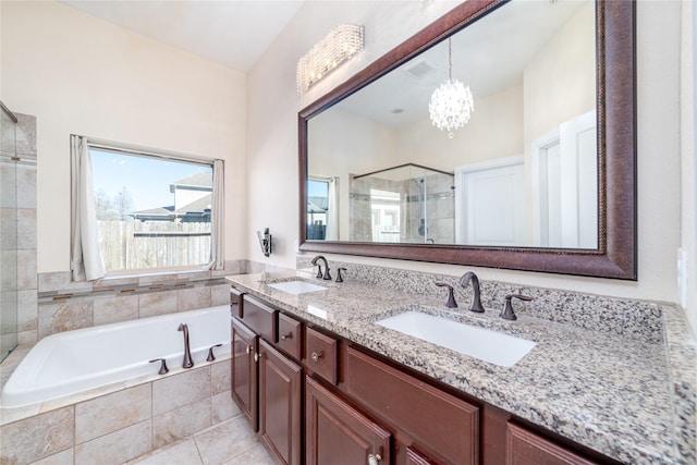 bathroom featuring tile patterned flooring, vanity, separate shower and tub, and an inviting chandelier