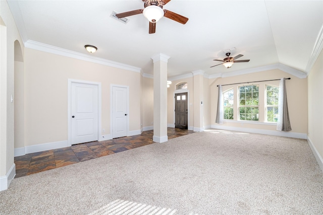 unfurnished living room with dark colored carpet, ceiling fan, ornate columns, and crown molding