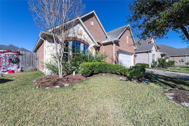 view of front of house featuring a front yard and a garage