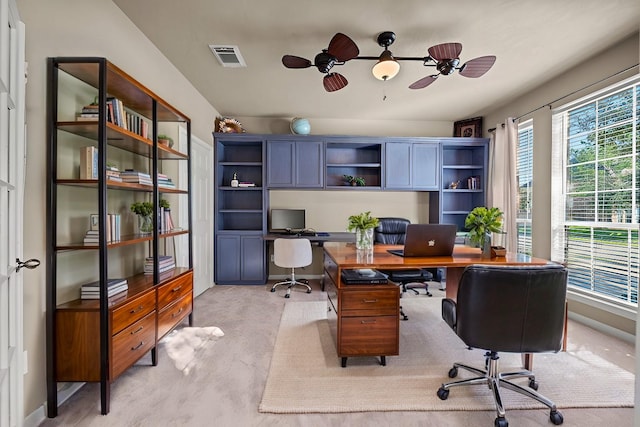 home office featuring light colored carpet and ceiling fan