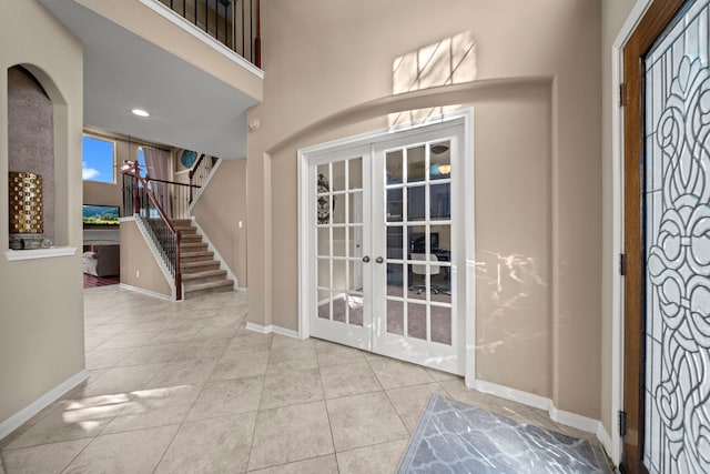 tiled entrance foyer featuring french doors