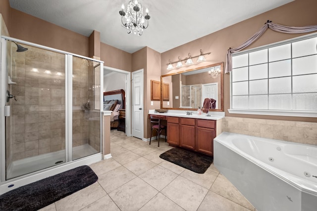 bathroom with tile patterned floors, vanity, shower with separate bathtub, and a notable chandelier