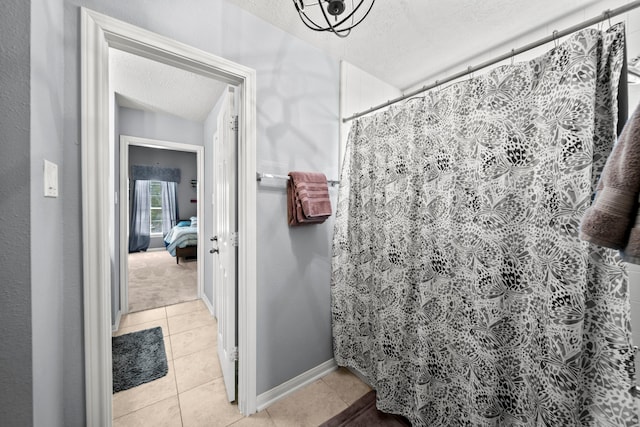 bathroom with tile patterned flooring, a textured ceiling, and a shower with shower curtain