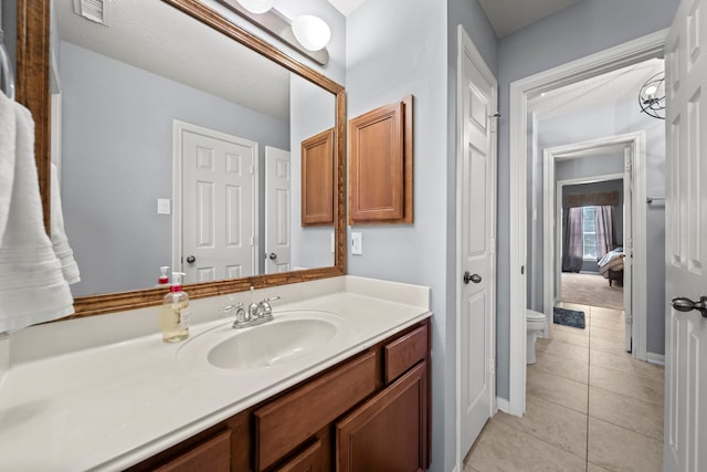 bathroom featuring tile patterned flooring, vanity, and toilet