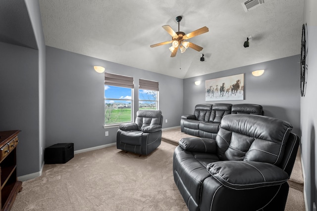 interior space featuring a textured ceiling, ceiling fan, light colored carpet, and lofted ceiling