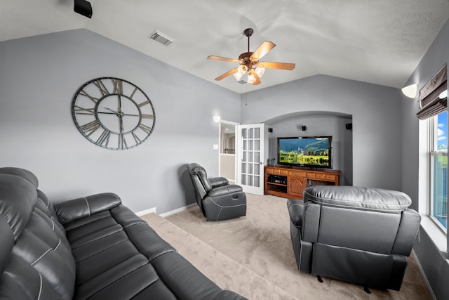 carpeted living room with ceiling fan, lofted ceiling, and a textured ceiling