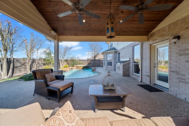 view of patio featuring a fenced in pool and ceiling fan