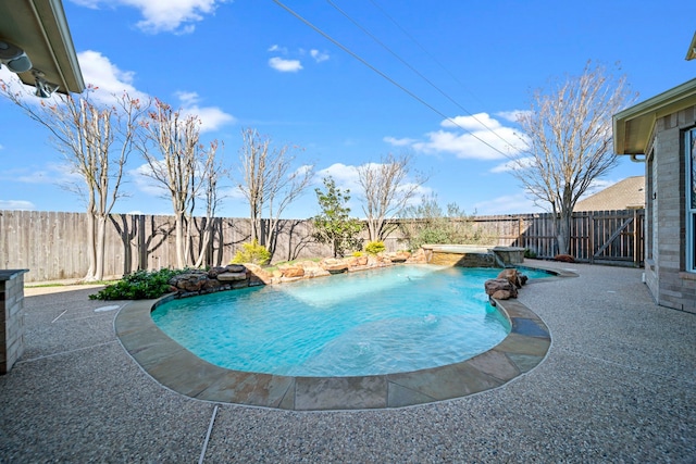 view of swimming pool featuring pool water feature and a patio