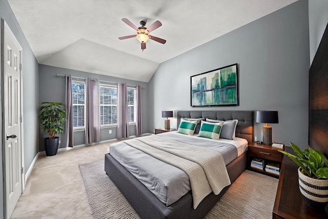 carpeted bedroom with ceiling fan and lofted ceiling