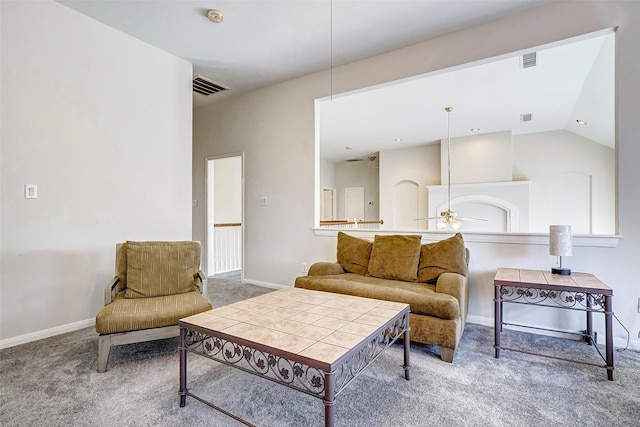 living room with ceiling fan, carpet floors, and vaulted ceiling