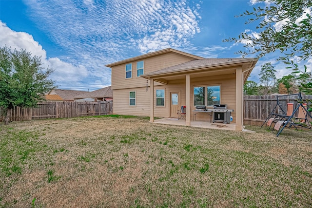 back of property featuring a patio area and a yard