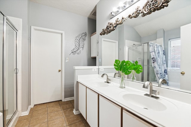 bathroom with tile patterned flooring, vanity, and walk in shower