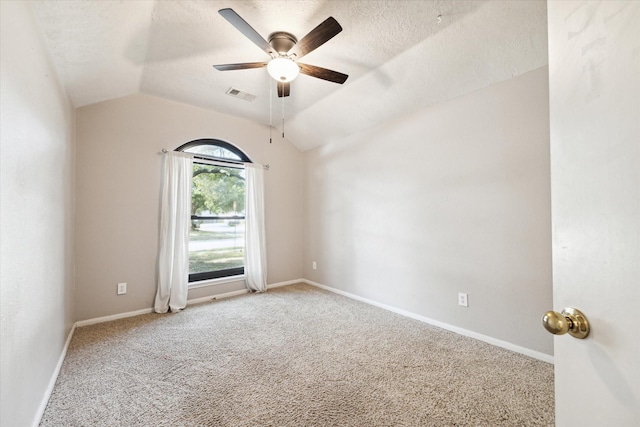 empty room with ceiling fan, carpet floors, a textured ceiling, and vaulted ceiling