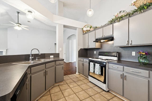 kitchen with gray cabinets, ceiling fan, white gas stove, and light tile patterned floors