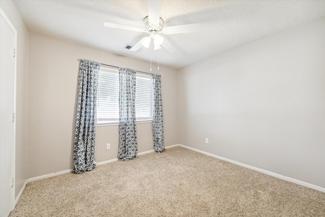 spare room with ceiling fan, carpet floors, and a textured ceiling