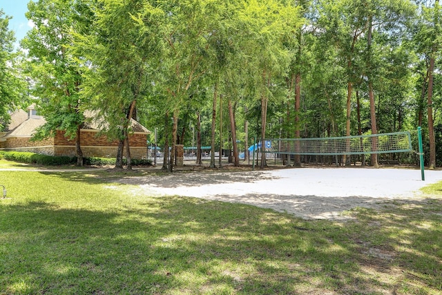 view of property's community featuring volleyball court and a lawn