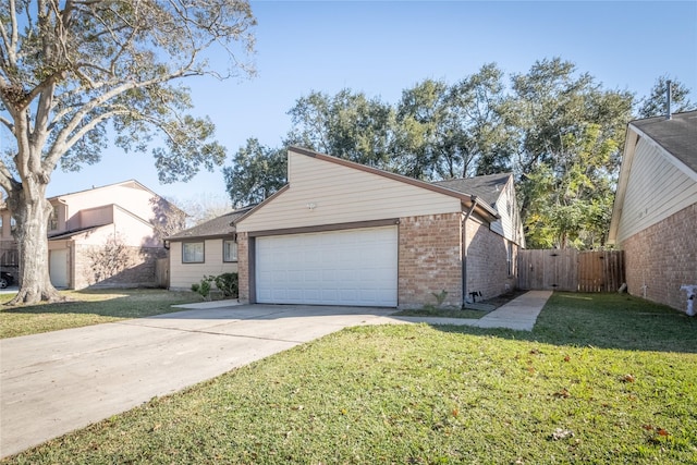 view of front of home with a front lawn and a garage