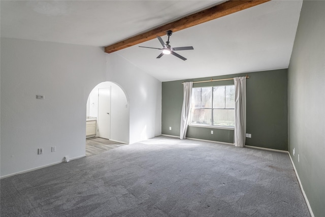 carpeted spare room featuring lofted ceiling with beams and ceiling fan