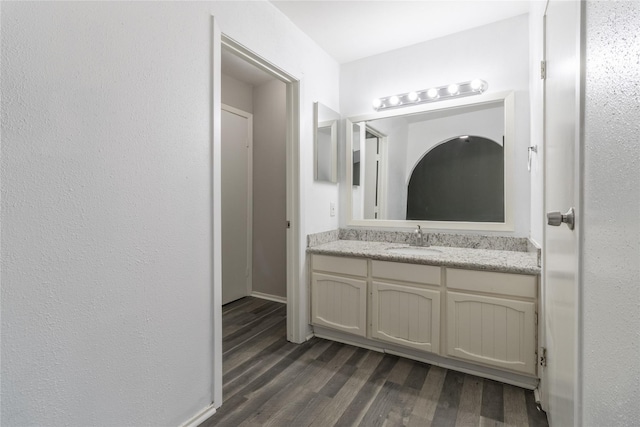 bathroom with hardwood / wood-style floors and vanity