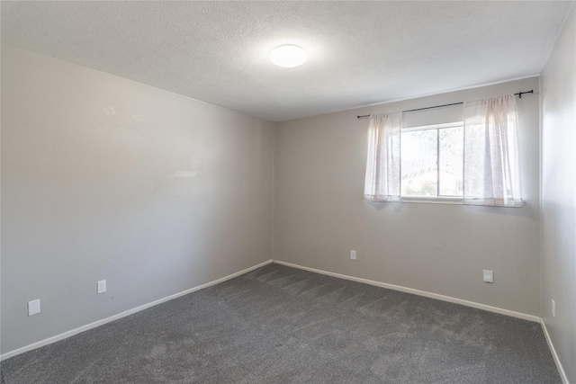 carpeted empty room featuring a textured ceiling