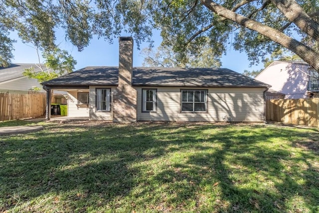 rear view of property with a yard