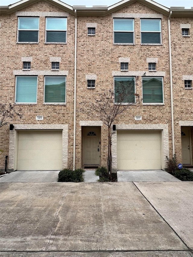 multi unit property featuring a garage