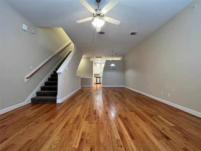 unfurnished living room featuring ceiling fan and light hardwood / wood-style flooring