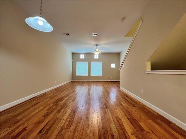 unfurnished living room featuring wood-type flooring and ceiling fan